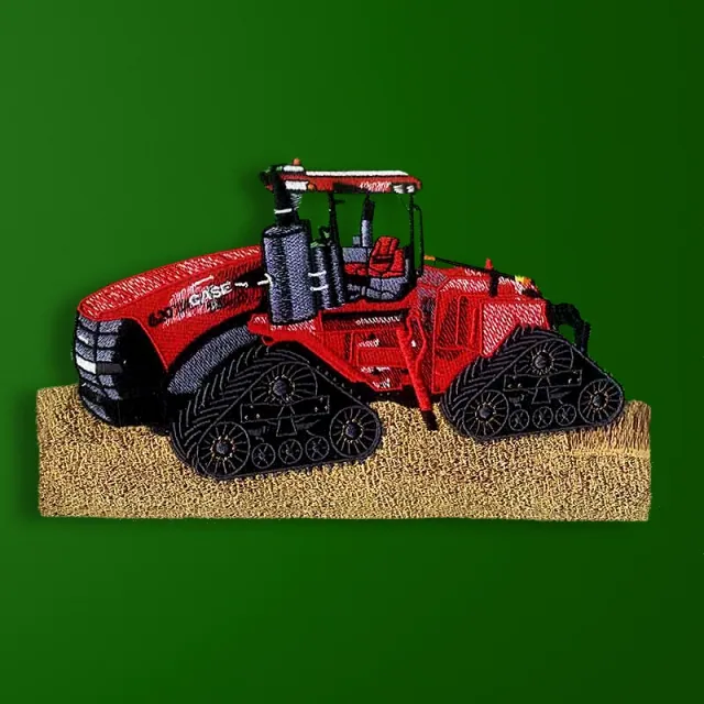 Red agricultural tractor with four track units in an embroidery design